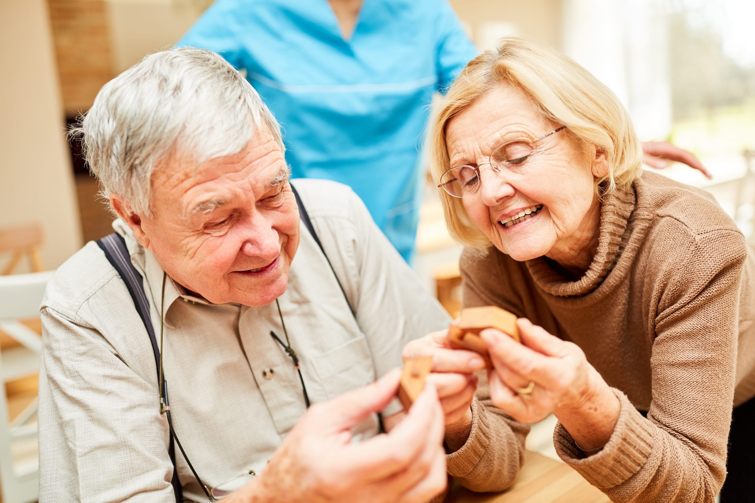 elderly residents completing a wooden puzzle at a care home in huddersfield, scissett